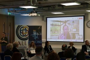 First panel of the conference, featuring the chair, two speakers, two discussants, and Irish Sign Language interpretation.