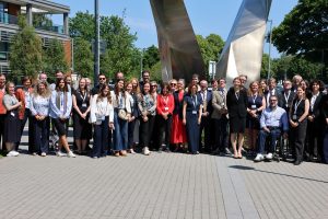 All conference participants standing outside on MU Campus.
