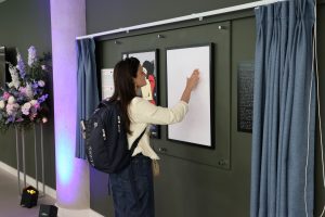 Conference participant with their hand on the canvas to experience the artwork through touch.